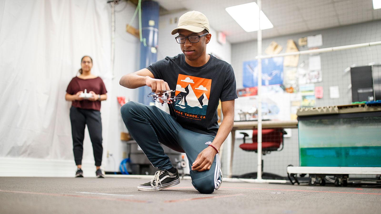 student flying drone