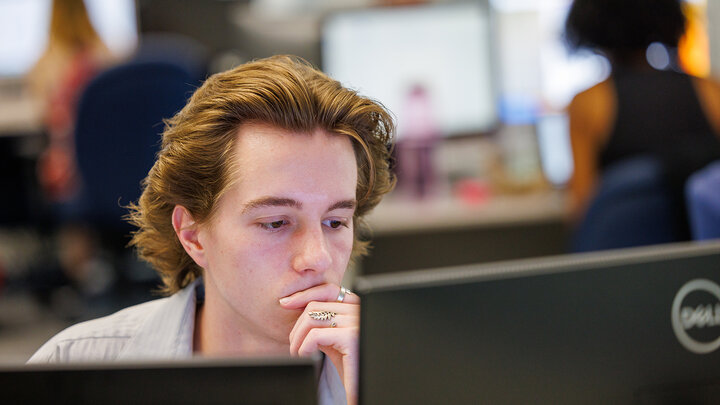 Ethan Dunn, a senior political science major and UCARE student from Omaha, works on a computer.