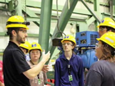 Student interns in yellow hard hats listen to a tour guide at Cooper Nuclear Station, Nebraska.