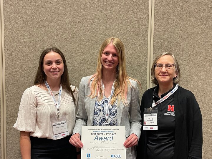 Members of the Diefes-Dux research team, including Kayla Ney and Emily Strautman, smile upon receiving a Best Paper - 2nd Place Award from the American Society for Engineering Education First Year Programs Division.