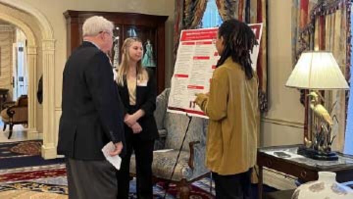 students showing poster project at the capital