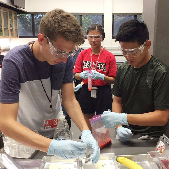 UBMS students working in lab wearing goggles and gloves